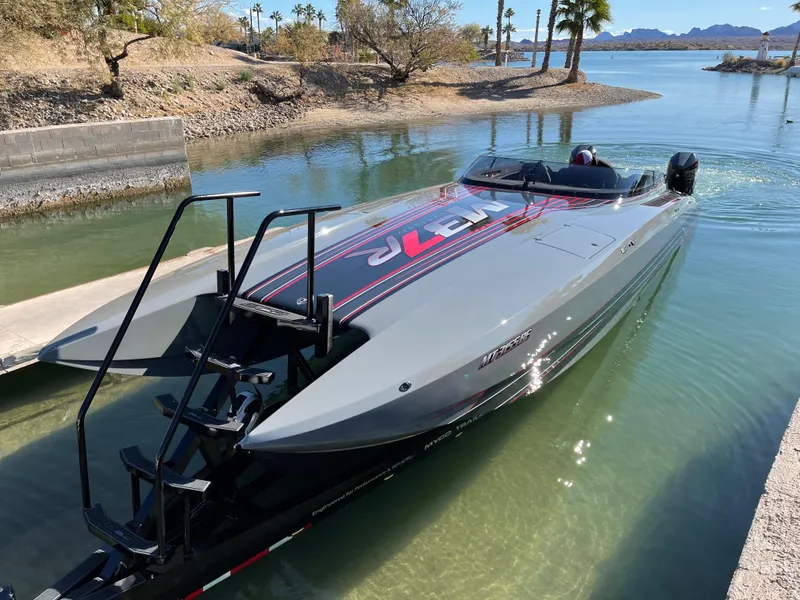 Slide: The Image of 2021 Daves Custom Boats M-37R in water, sleek design, gray with red accents. - 11