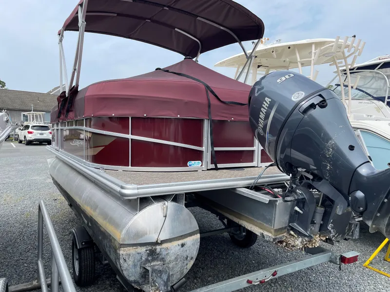 Slide: The Image of 2022 Starcraft LX20R pontoon boat with Yamaha outboard motor, parked on a trailer. - 7