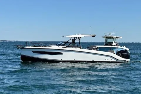 Slide: The Image of 2025 Navan C30 boat cruising on open water under clear blue skies. - 10