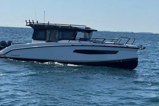 Slide: The Image of 2025 Navan C30 boat cruising on open water under clear skies. - 19