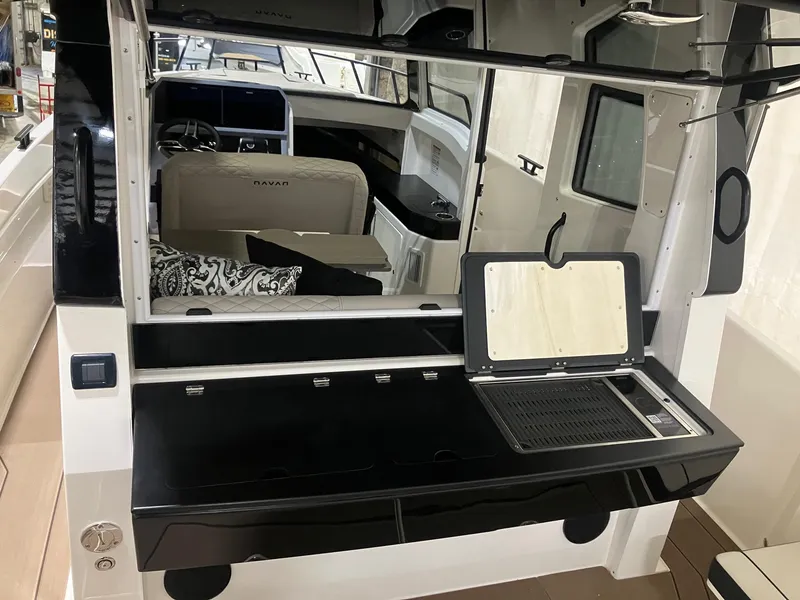 Slide: The Image of Interior of 2025 Navan C30 boat with modern kitchen and seating area. - 2