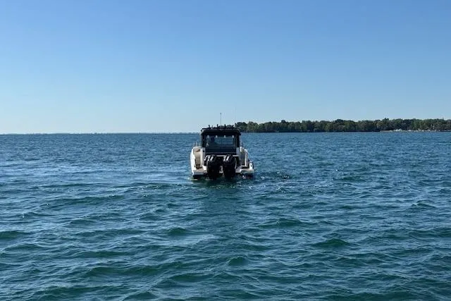 Slide: The Image of Navan C30 boat on open water, 2025 model, under clear blue sky. - 23