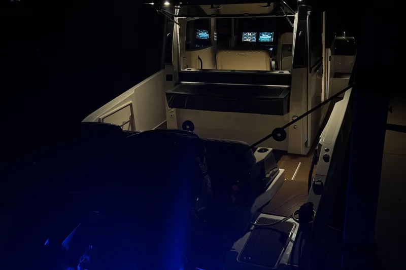Slide: The Image of Navan C30 2025 boat interior at night with illuminated controls and seating. - 25