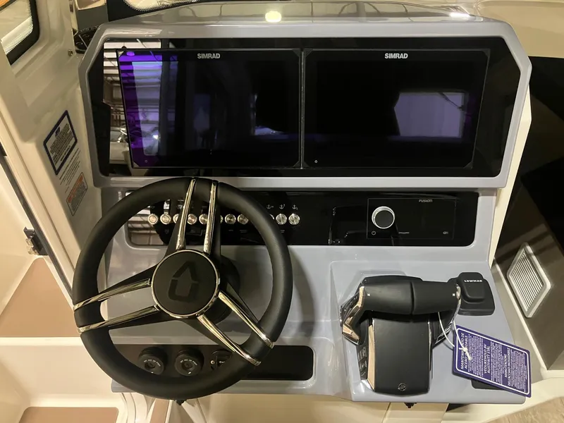 Slide: The Image of 2025 Navan C30 boat dashboard with dual Simrad displays and steering wheel. - 6