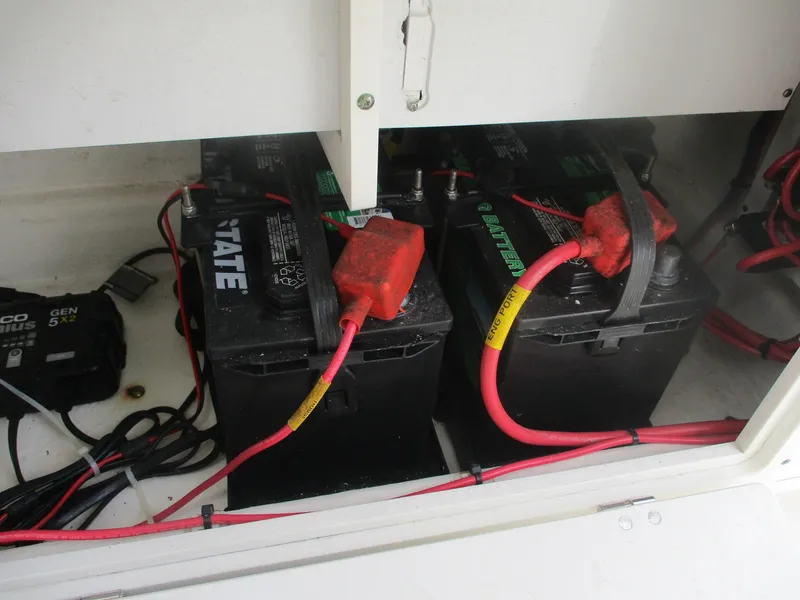 Slide: The Image of Batteries in a 2022 Cobia 237 Center Console boat with red cables. - 10