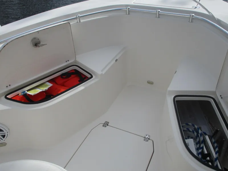Slide: The Image of 2022 Cobia 237 Center Console boat interior with storage compartments. - 22