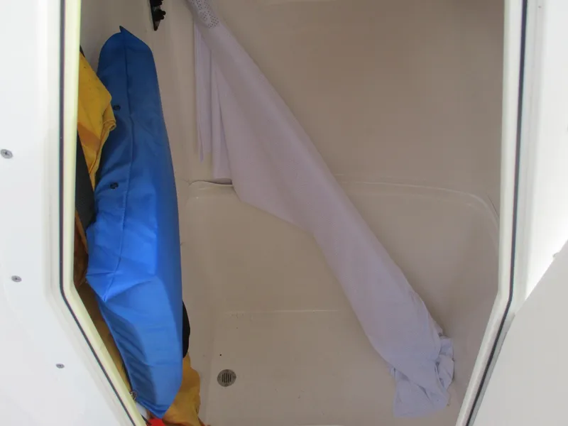 Slide: The Image of Storage compartment in a 2022 Cobia 237 Center Console boat with life jackets. - 26