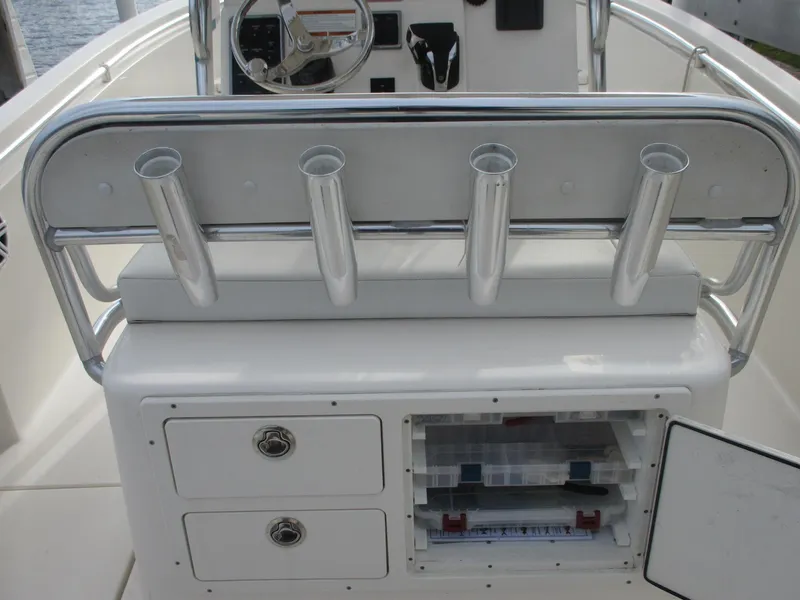Slide: The Image of 2022 Cobia 237 Center Console boat with rod holders and storage compartments. - 29