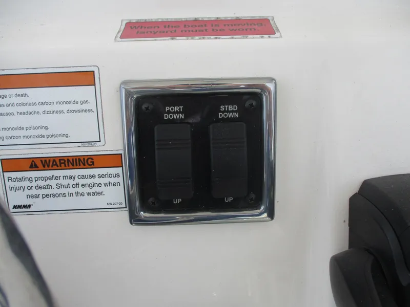 Slide: The Image of Control panel on a 2022 Cobia 237 Center Console boat with warning labels. - 33