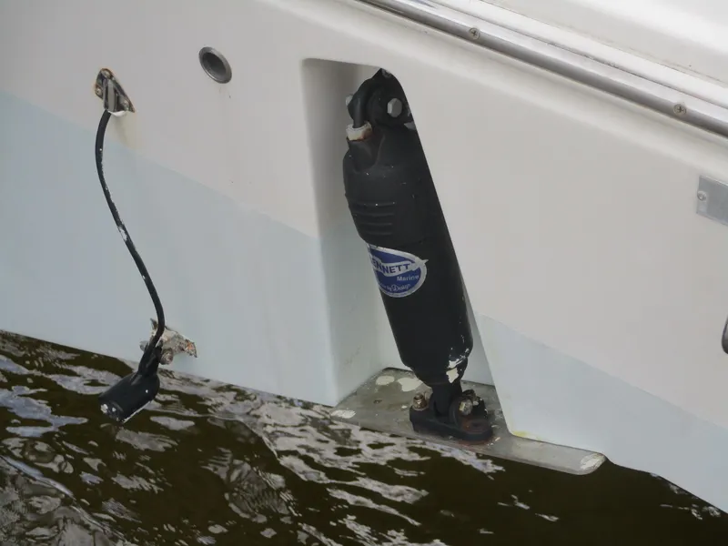 Slide: The Image of 2022 Cobia 237 Center Console boat with trim tab and sensor in water. - 35