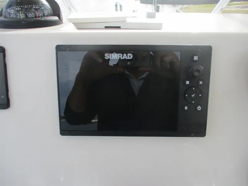 Slide: The Image of Simrad display on 2022 Cobia 237 Center Console boat dashboard. - 5