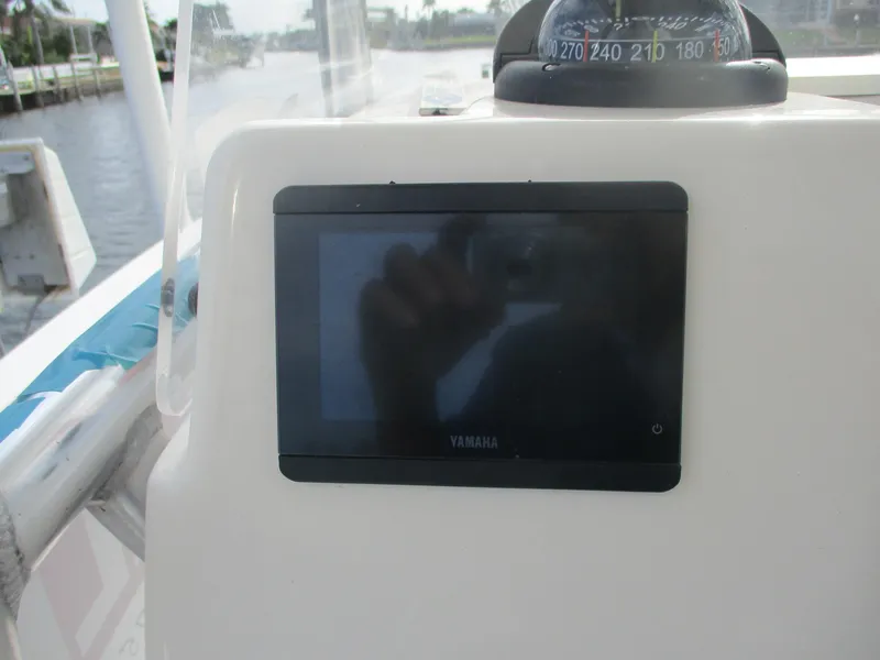 Slide: The Image of 2022 Cobia 237 Center Console dashboard with Yamaha display and compass. - 6