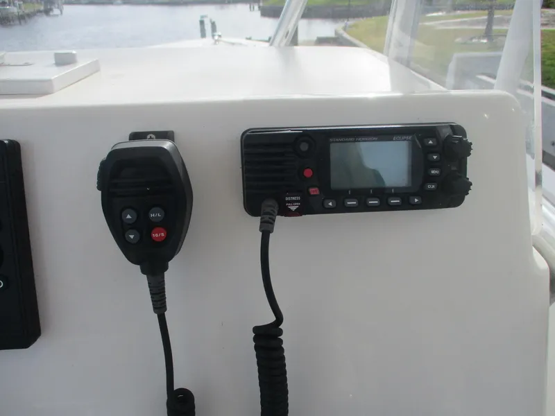 Slide: The Image of VHF radio and microphone on 2022 Cobia 237 Center Console boat dashboard. - 7