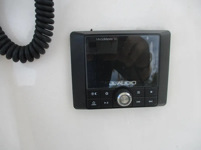 Slide: The Image of JL Audio MediaMaster 50 control panel on 2022 Cobia 237 Center Console boat. - 8