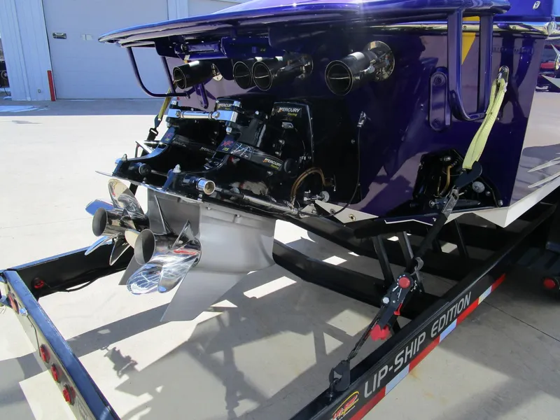 Slide: The Image of 2005 Cigarette 39 Top Gun boat cockpit with gauges, steering wheel, and purple-accented seating. - 11