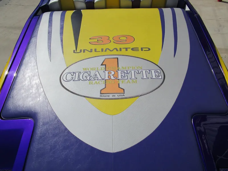 Slide: The Image of 2005 Cigarette 39 Top Gun dashboard with gauges and controls, featuring a vibrant purple design. - 12