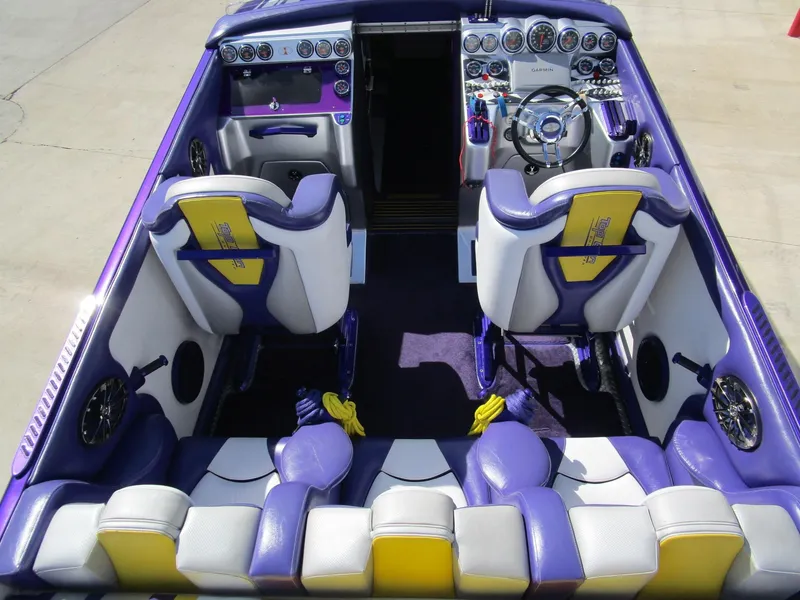 Slide: The Image of Interior of a 2005 Cigarette 39 Top Gun boat with purple and white seating. - 13