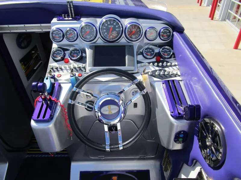 Slide: The Image of 2005 Cigarette 39 Top Gun boat interior with purple and white seating and audio speakers. - 15