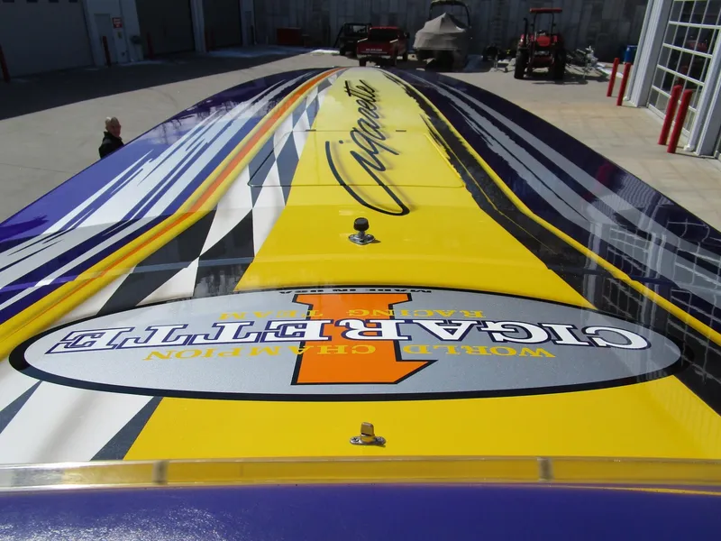 Slide: The Image of 2005 Cigarette 39 Top Gun engine compartment with blue and chrome components. - 24