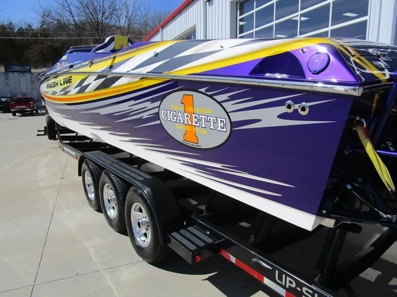 Slide: The Image of Interior of 2005 Cigarette 39 Top Gun boat with purple and yellow seating. - 8