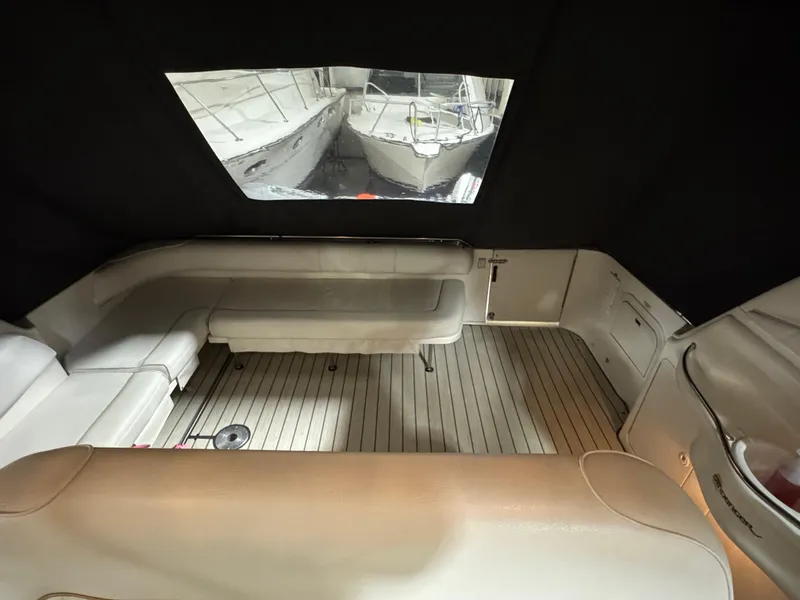 Slide: The Image of 1999 Sea Ray 400 Sundancer yacht interior with open storage compartment and visible cleaning supplies. - 10