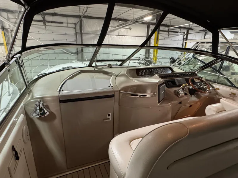 Slide: The Image of 1999 Sea Ray 400 Sundancer interior with white leather seating and wooden flooring. - 12