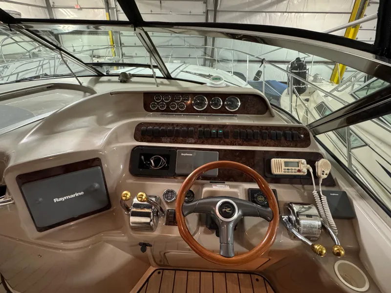 Slide: The Image of 1999 Sea Ray 400 Sundancer kitchen with wood cabinets, fridge, and microwave. - 14