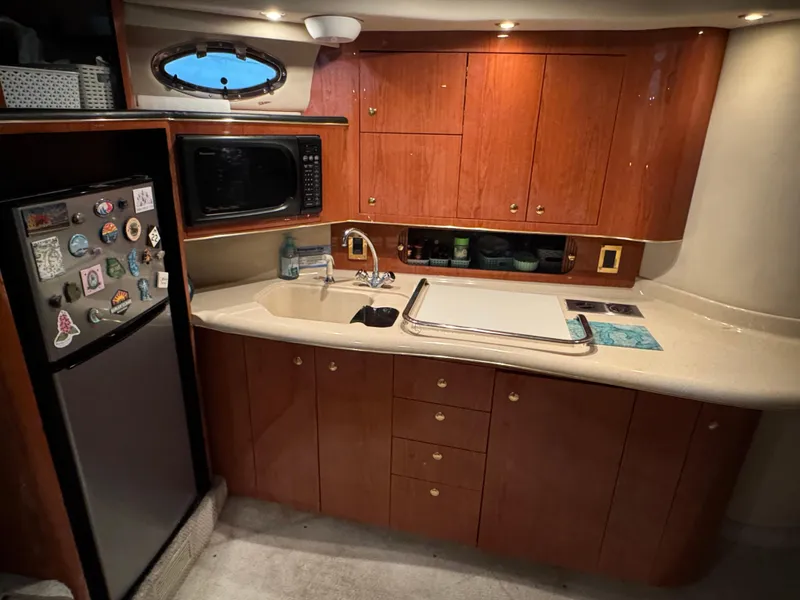 Slide: The Image of Luxurious interior of 1999 Sea Ray 400 Sundancer yacht with plush curved seating. - 15