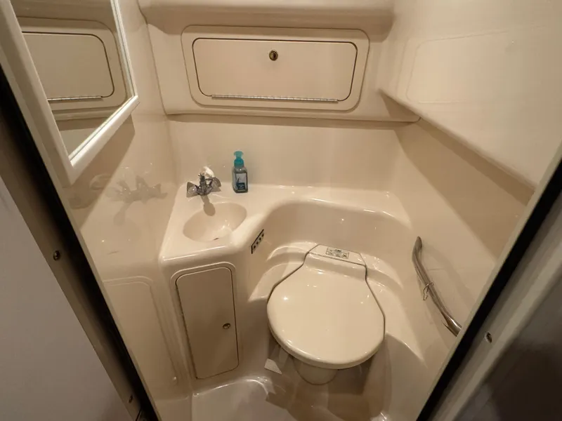 Slide: The Image of 1999 Sea Ray 400 Sundancer closet with shelves, hangers, and fire extinguisher. - 20