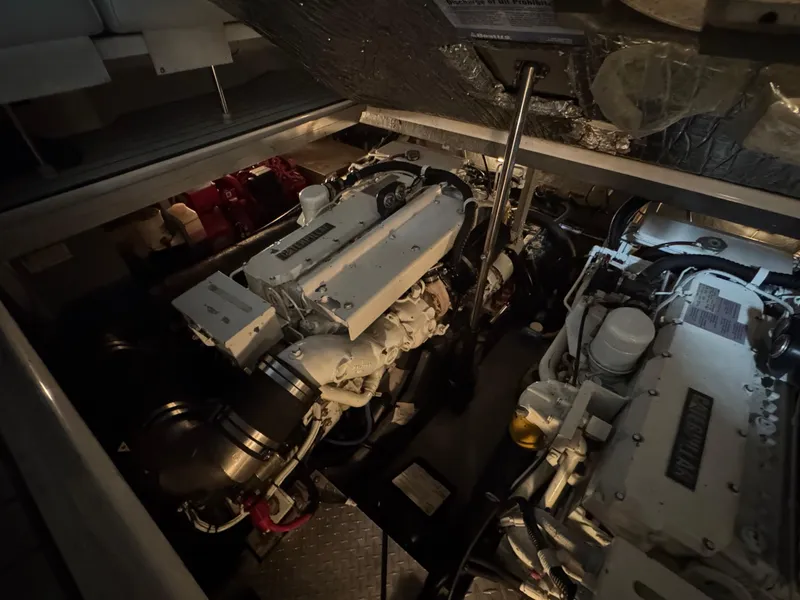 Slide: The Image of Engine room of a 1999 Sea Ray 400 Sundancer yacht, featuring mechanical components. - 25