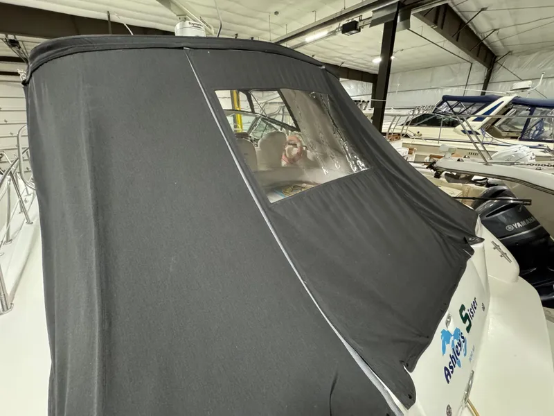 Slide: The Image of 1999 Sea Ray 400 Sundancer with black canvas cover in a boat storage facility. - 4