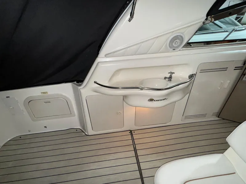 Slide: The Image of Storage compartment on a 1999 Sea Ray 400 Sundancer with cleaning supplies. - 8