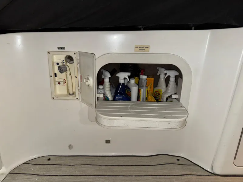 Slide: The Image of 1999 Sea Ray 400 Sundancer interior with seating and wooden flooring. - 9