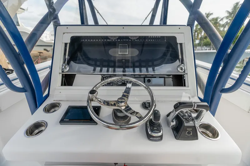 Slide: The Image of 2019 SeaHunter 35 Tournament boat dashboard with steering wheel and controls. - 10