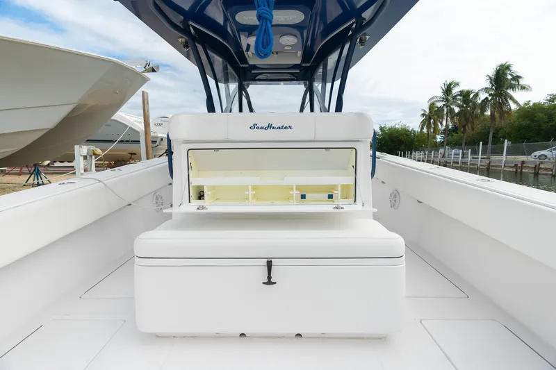 Slide: The Image of 2019 SeaHunter 35 Tournament boat interior with open storage compartment, showcasing spacious deck design. - 13