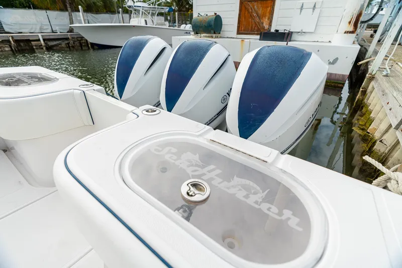 Slide: The Image of 2019 SeaHunter 35 Tournament boat with triple outboard engines docked at marina. - 15