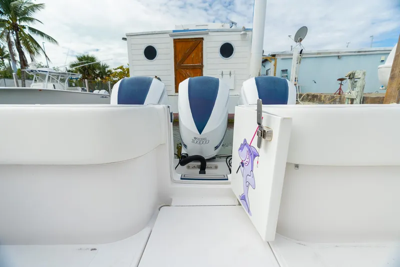 Slide: The Image of 2019 SeaHunter 35 Tournament boat with twin engines, docked near a houseboat. - 16