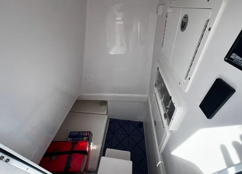 Slide: The Image of Interior cabin of 2019 SeaHunter 35 Tournament boat, featuring storage and seating area. - 18