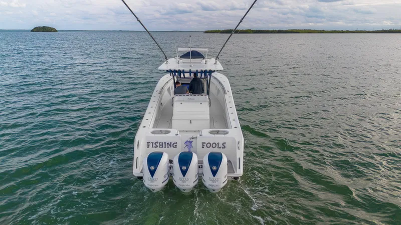 Slide: The Image of 2019 SeaHunter 35 Tournament boat on open water, featuring triple outboard engines. - 4