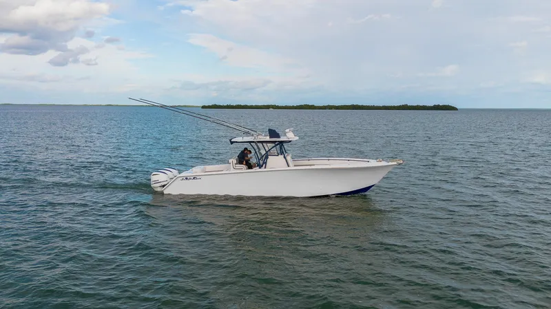Slide: The Image of 2019 SeaHunter 35 Tournament boat cruising on open water under a cloudy sky. - 6