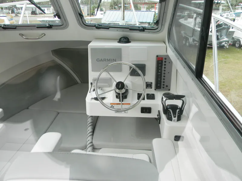Slide: The Image of 2025 Parker 2420 Sport Cabin interior with Garmin navigation system and steering wheel. - 7