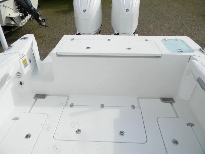 Slide: The Image of 2025 Parker 2420 Sport Cabin boat deck with dual outboard motors. - 9