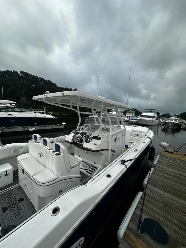 Slide: The Image of 2011 Cigarette 39 TOP FISH boat docked at marina under cloudy skies. - 3