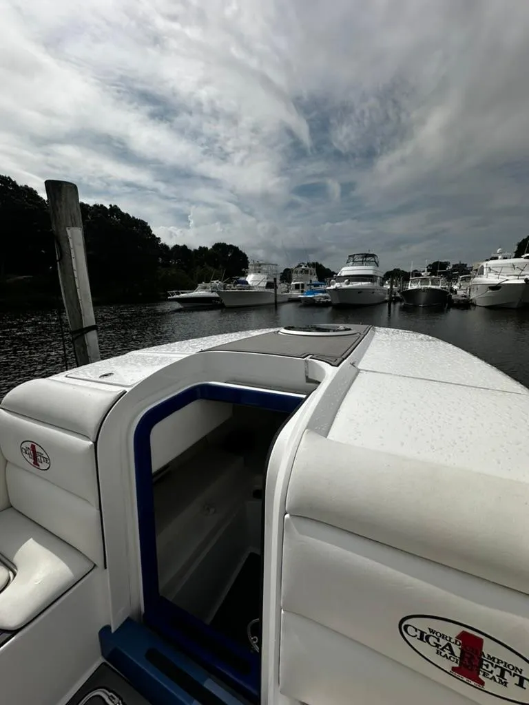 Slide: The Image of 2011 Cigarette 39 TOP FISH boat docked in a marina under cloudy skies. - 8