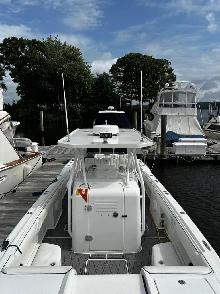 Slide: The Image of 2011 Cigarette 39 TOP FISH boat docked, surrounded by trees and other vessels. - 9