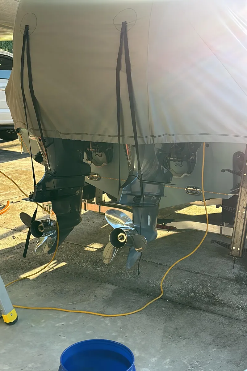 Slide: The Image of 2022 Sea Hunt Gamefish 27 boat engines with protective cover in sunlight. - 3