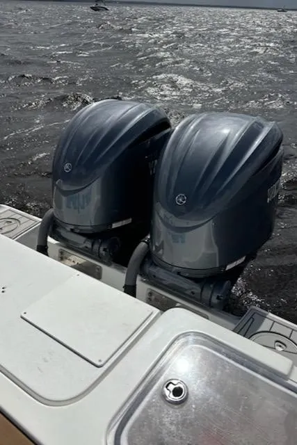 Slide: The Image of 2022 Sea Hunt Gamefish 27 boat with dual outboard motors on water. - 7