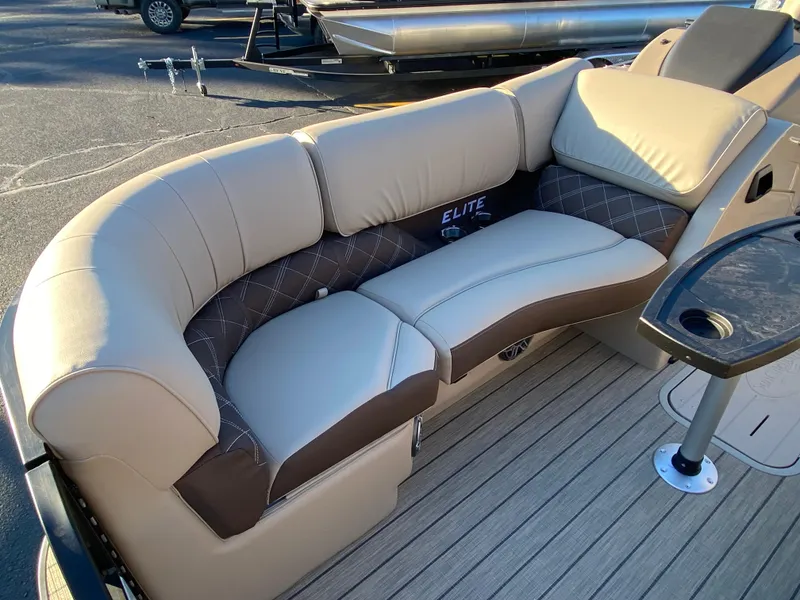 Slide: The Image of 2025 SunCatcher Elite 324 SS boat interior with plush seating and elegant design. - 10