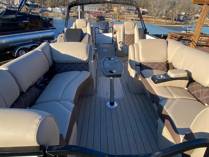 Slide: The Image of Luxurious 2025 SunCatcher Elite 324 SS pontoon boat with spacious seating and elegant design. - 12
