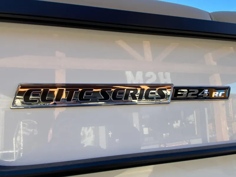 Slide: The Image of 2025 SunCatcher Elite 324 SS emblem on a boat exterior. - 13